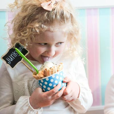 Kid eating dessert, posing for a photo