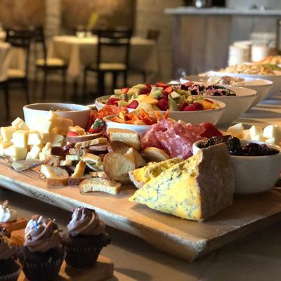 Different types of smoked meat, cheese and salads
