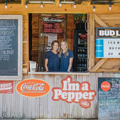 Exterior, two female staff by the window counter