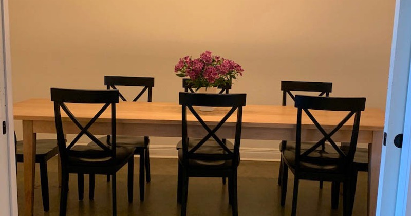 Interior, a table with chairs and flowers under hanging light