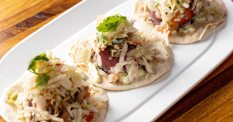 Three tuna tacos on a plate