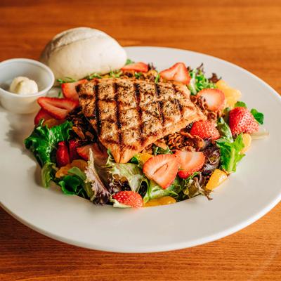 Grilled salmon salad with mixed greens, sliced strawberries and mandarin oranges