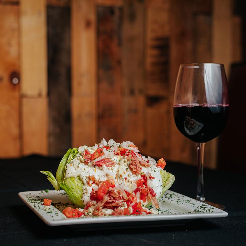 Wedge Salad served with a glass of wine