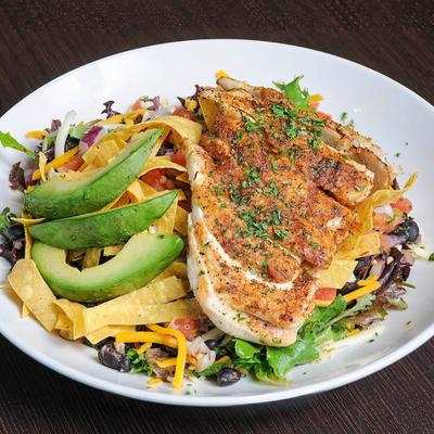 Blackened chicken served with tortilla strips, avocado, cheddar and black beans