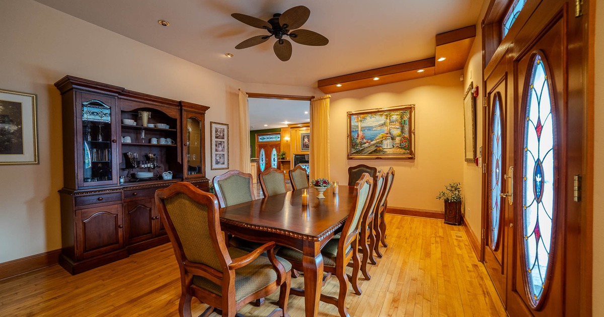 A tastefully decorated dining room with a wooden table and comfortable chairs