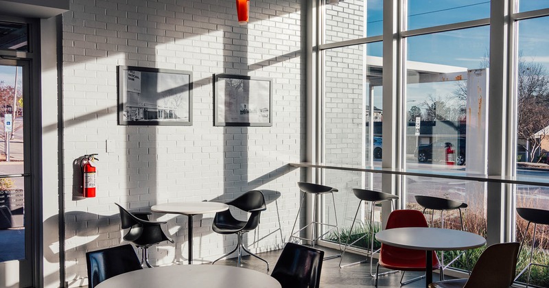 Interior, seating area, white brick wall, large shop window with high seating