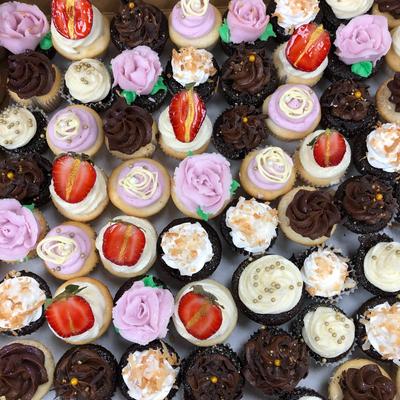 Assorted cupcakes grouped together, top view