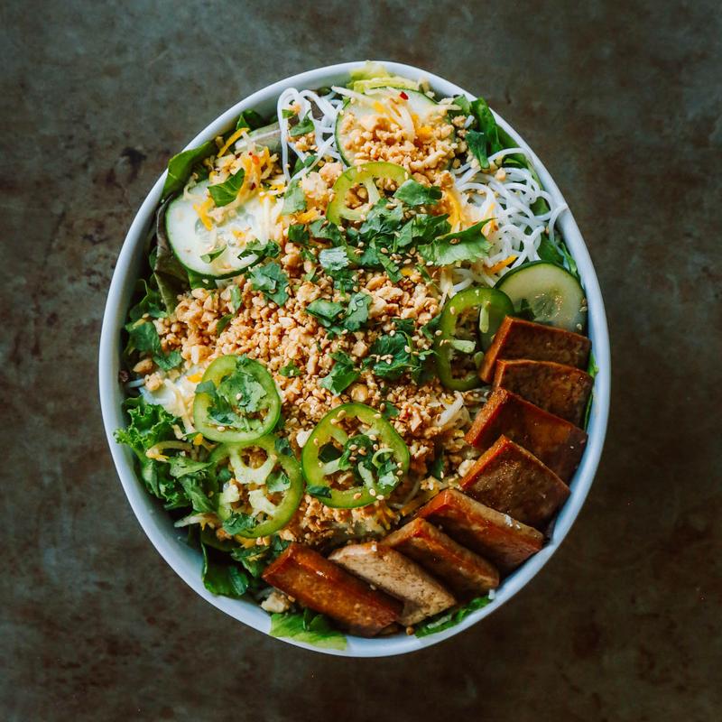 Thai Peanut Salad, with rice noodles, tofu, pickled carrots, cucumber, jalapeno, and mixed greens.