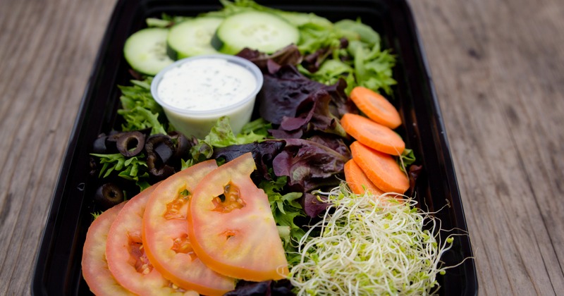 Small salad served with a dressing