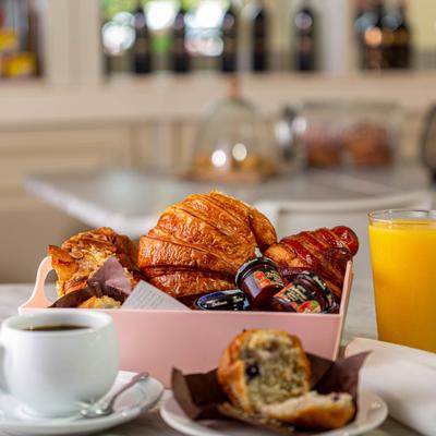 Croissants and muffins served with coffee and orange juice