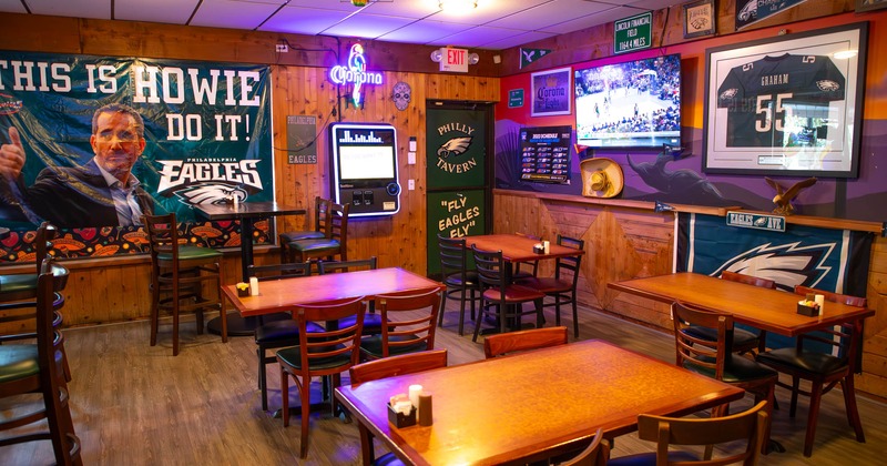Interior, tables and chairs, NFL Eagles banners, flags and jerseys used as decoration