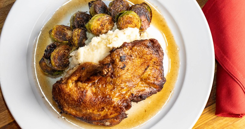 Roasted half chicken with mashed potatoes and brussels, top view