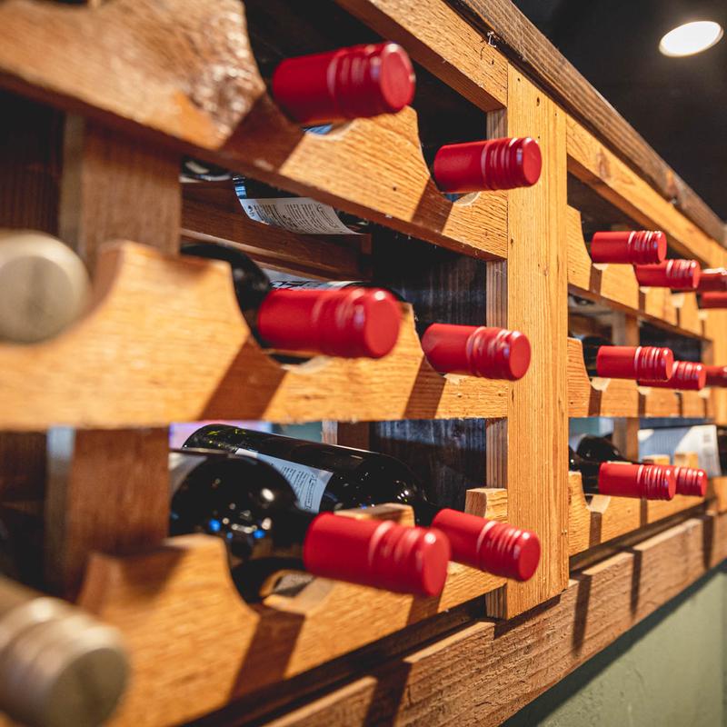Wine bottles, stacked on shelves