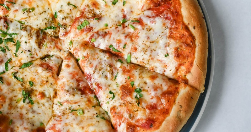 A sliced, served pizza