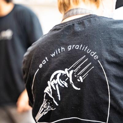 'Eat with Gratitude' written on the T-shirt