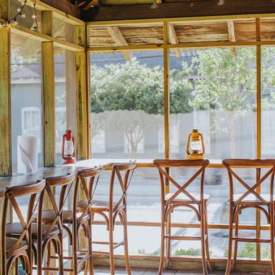 Patio with a dining counter with tall chairs by the window