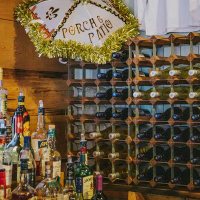 Interior, bar detail, Bottles and a Wine rack, decorated umbrella with the restaurant name on it