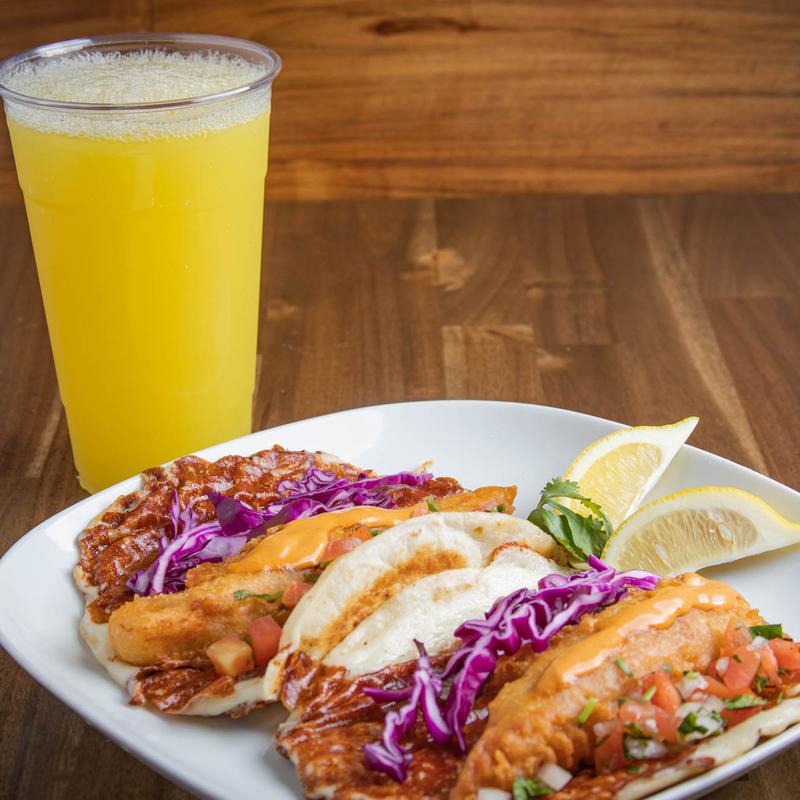 Fish tacos with glass of orange juice