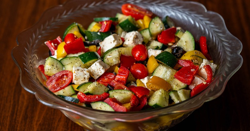 Greek Salad, with bell peppers, cherry tomatoes, black olives, cucumbers, and feta