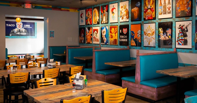 Interior, dining area, tables and chairs, seating booths, Mexican culture inspired posters