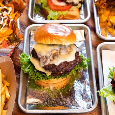 Cheeseburger with lettuce, tomato, onion, pickle and burger sauce