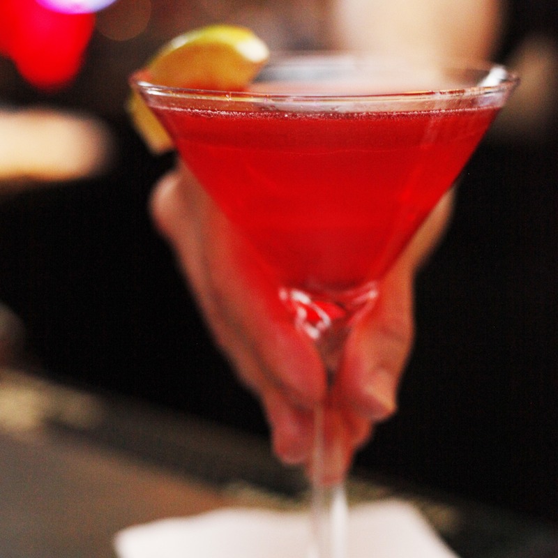 Hand holding a red cocktail, closeup