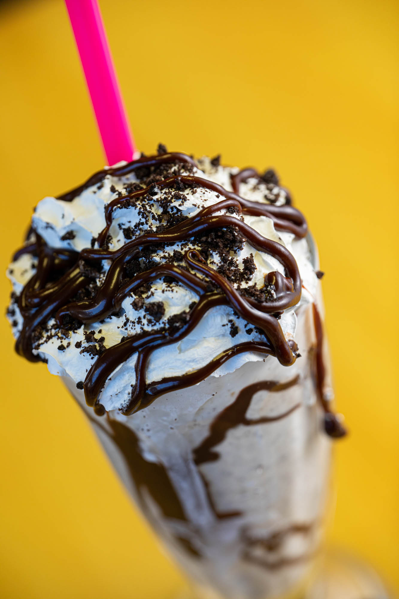 Milkshake, with chocolate syrup and sprinkles, closeup
