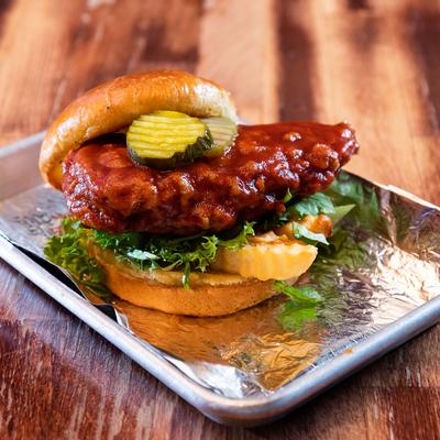 Fried chicken burger with Chicago mild sauce, lettuce, pickles and crinkle fries