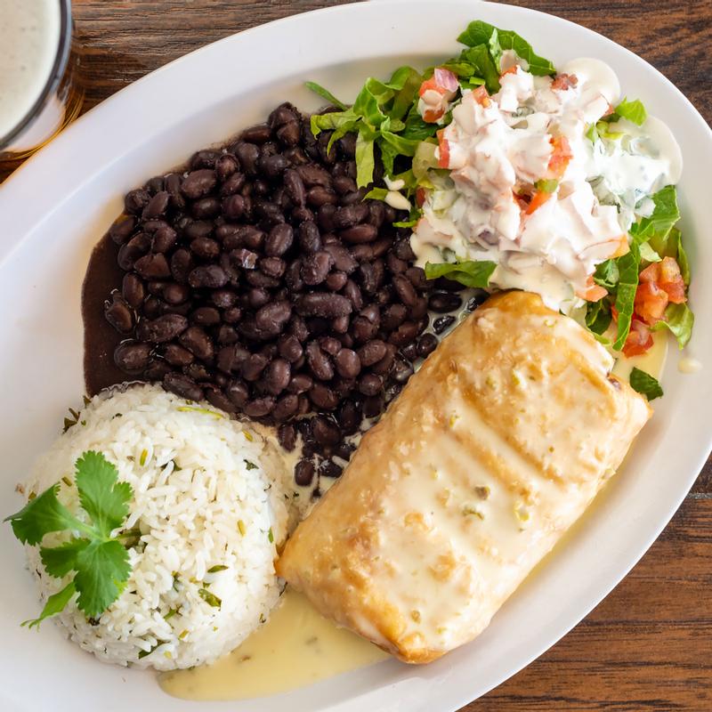 Chimichanga  served with rice,  veggie salad and  black beans, top view