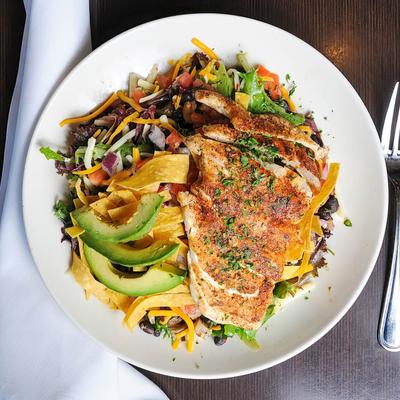 Blackened chicken with avocado, tortilla strips, black beans and cheddar cheese