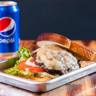 Burger with toasted bread, cheese, lettuce, tomato, onion, pickles and sauce