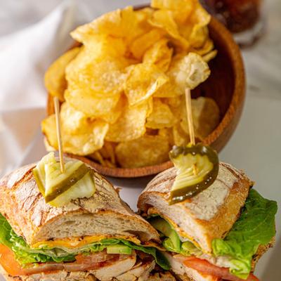 Chipotle Chicken Sandwich with lettuce, mayo and avocado, side of chips