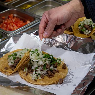 Staff member packing tacos