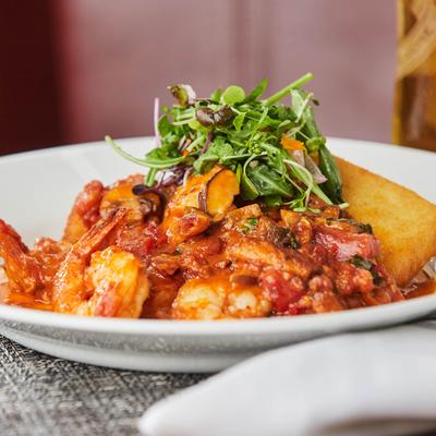 Mixed stew with tomato sauce and baked potato