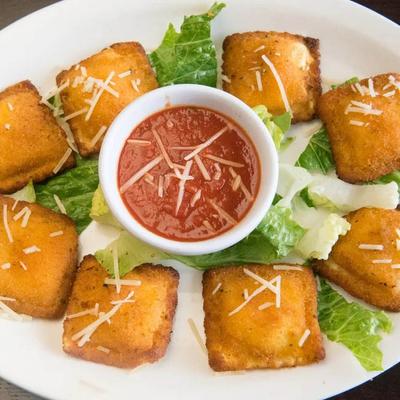 Breaded cheese ravioli with marinara.