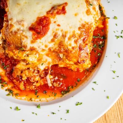 Baked lasagna with melted cheese and tomato sauce.