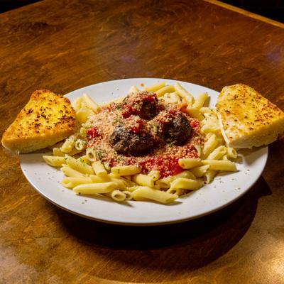 Plate with meatballs pasta on the table.