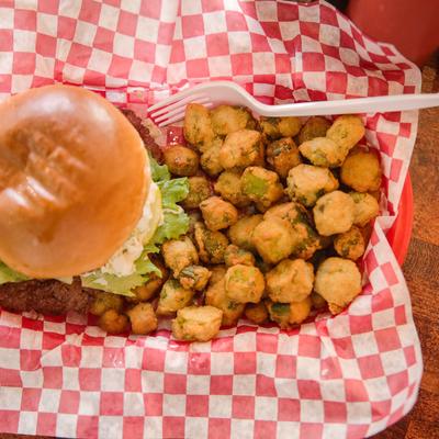 A burger with various sides.
