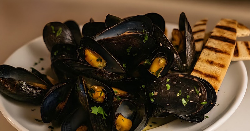 Grilled octopus, served with asparagus, cherry tomatoes, a lemon and olive oil dressing