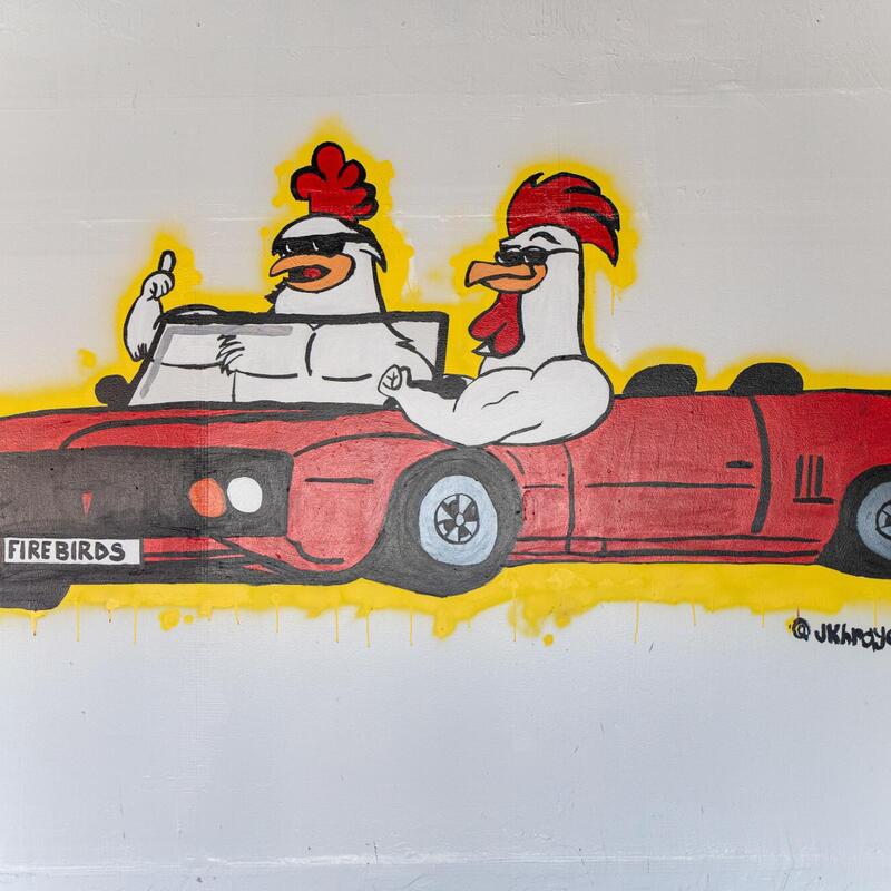 Chickens with glasses in a red car mural