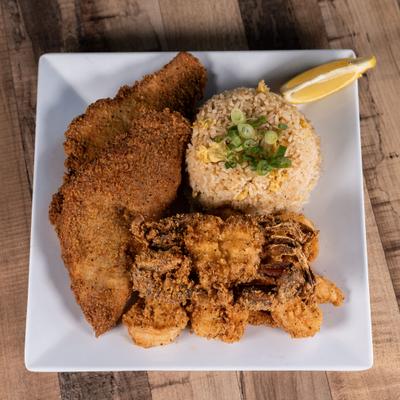 Asian Cajun platter served with rice and a lemon wedge.