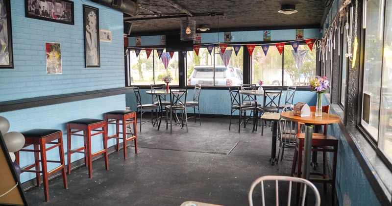 Interior, dining area, brick walls, tables, chairs, festive bunting, flowers on the tables