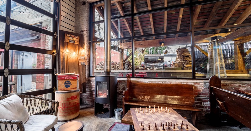 Interior seating area by the fireplace, chess board on the table