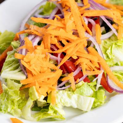 House Salad with lettuce, tomato, cucumber, onion, olive, carrots, peppers and cheese.