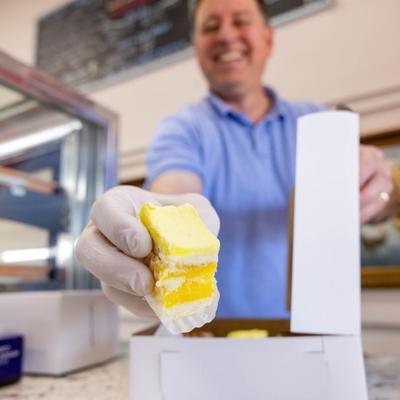 Employee packing cakes in a box.