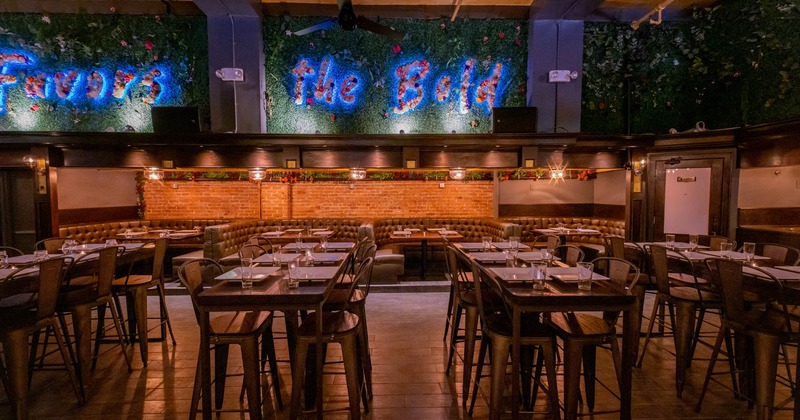 Interior, tables and chairs, seating booths, red brick wall, floral wall decoration, ceiling fans