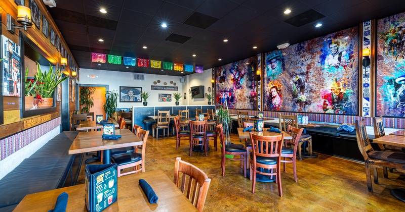 Interior, colorful dining area with art all over the walls