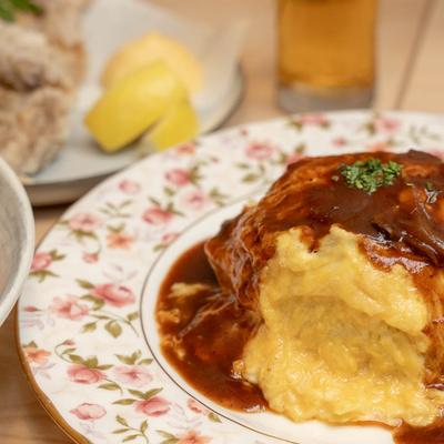 Japanese egg omelet dish with tomato based brisket fried rice and demi glace sauce.