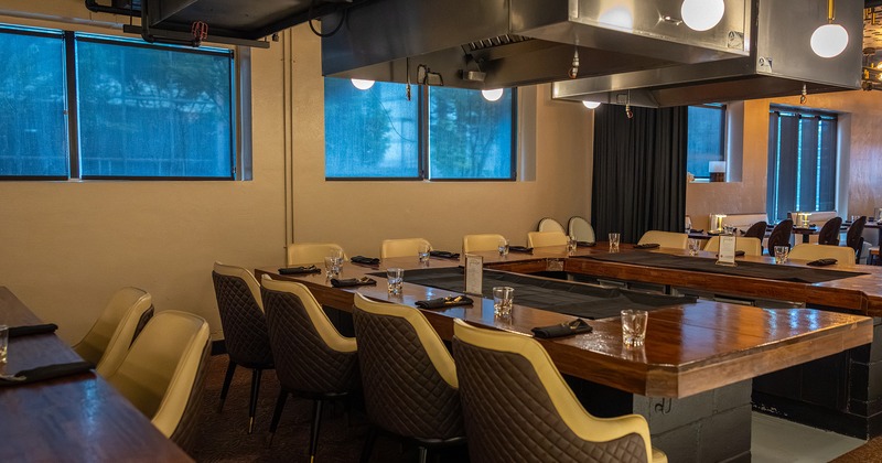 Modern interior of the dining area, tables with flat iron grill for food preparing