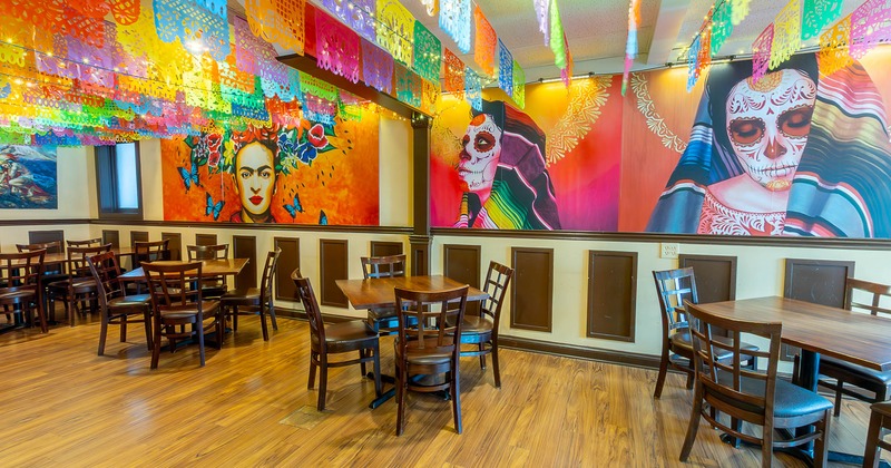 Interior seating area with chairs and tables, colorful Mexican decoration